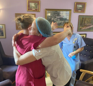 BCOP| carers at Robert Harvey House giving each other a hug